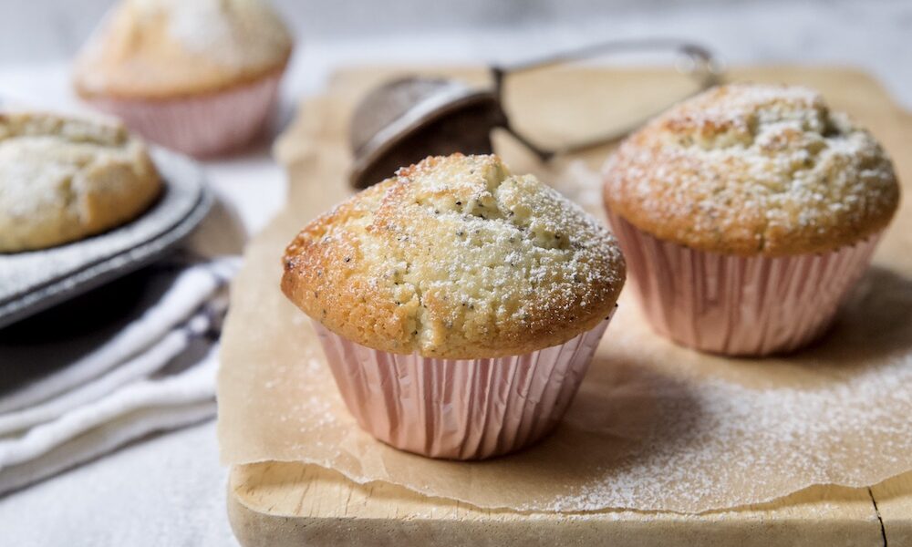 lemon and poppy seeds muffins on a wooden board