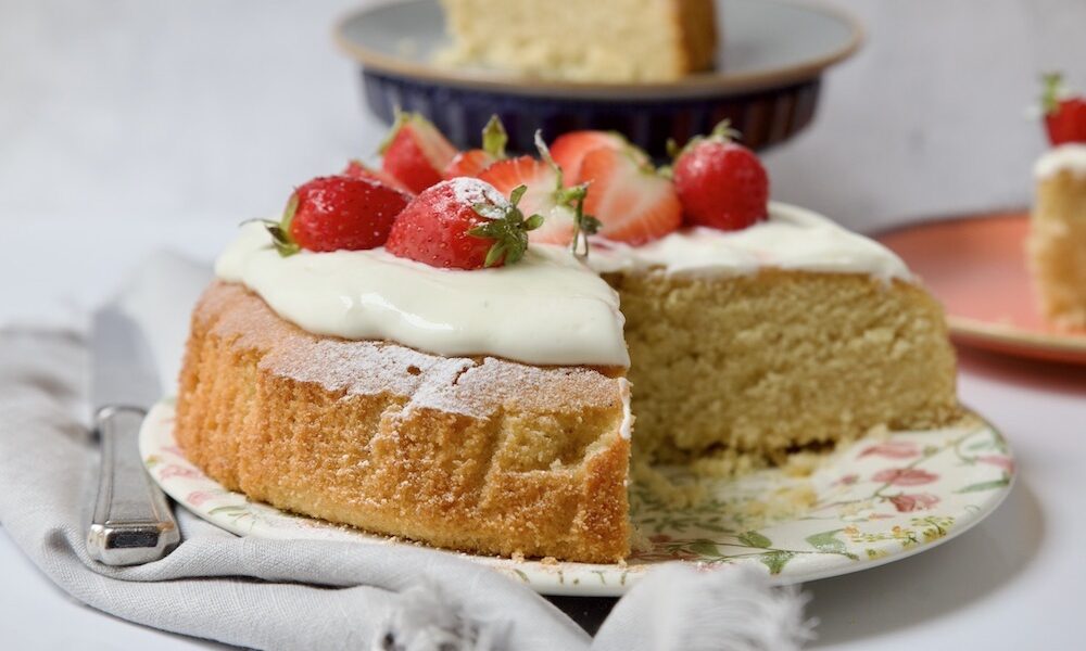 polenta cake sliced topped with strawberry and cream