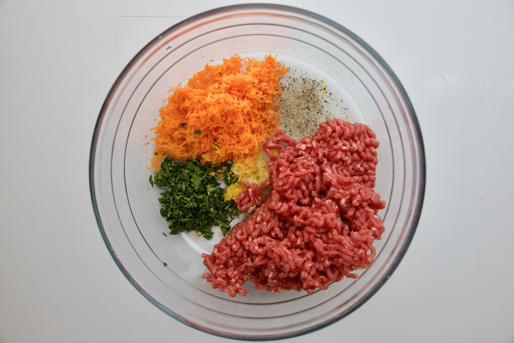 mincemeat herbs carrots salt and pepper in a bowl