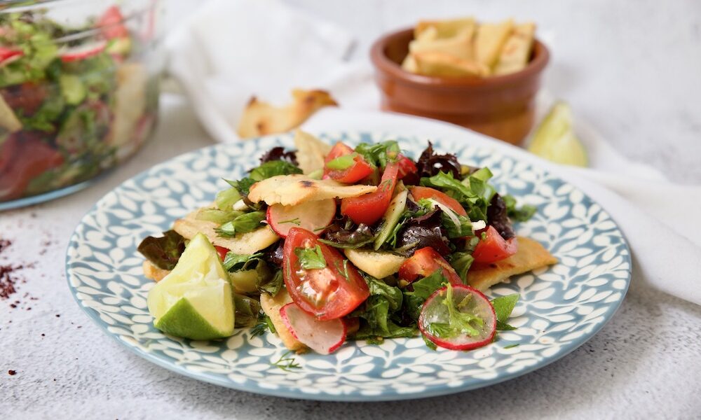 fattoush with lime wedge on a plate