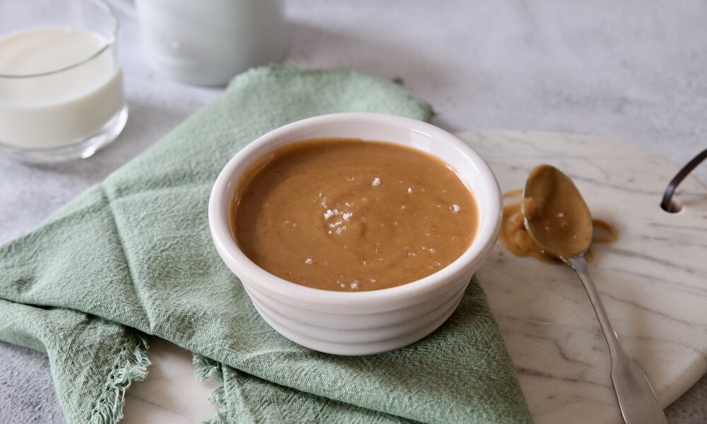 toffee sauce in a pot with a sprinkle of salt