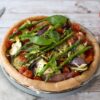 vegetable summer tart with asparagus and fresh basil leaves